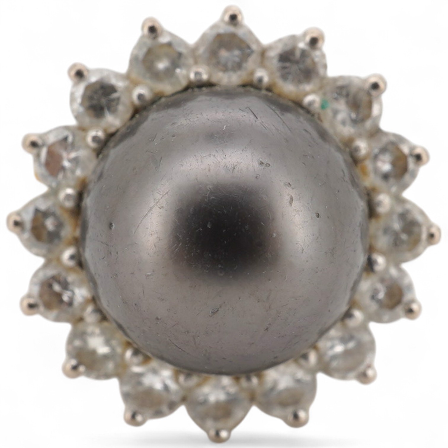 A modern 18ct gold and single stone Tahitian cultured pearl and diamond set circular cluster ring, size O, gross weight 7 grams.